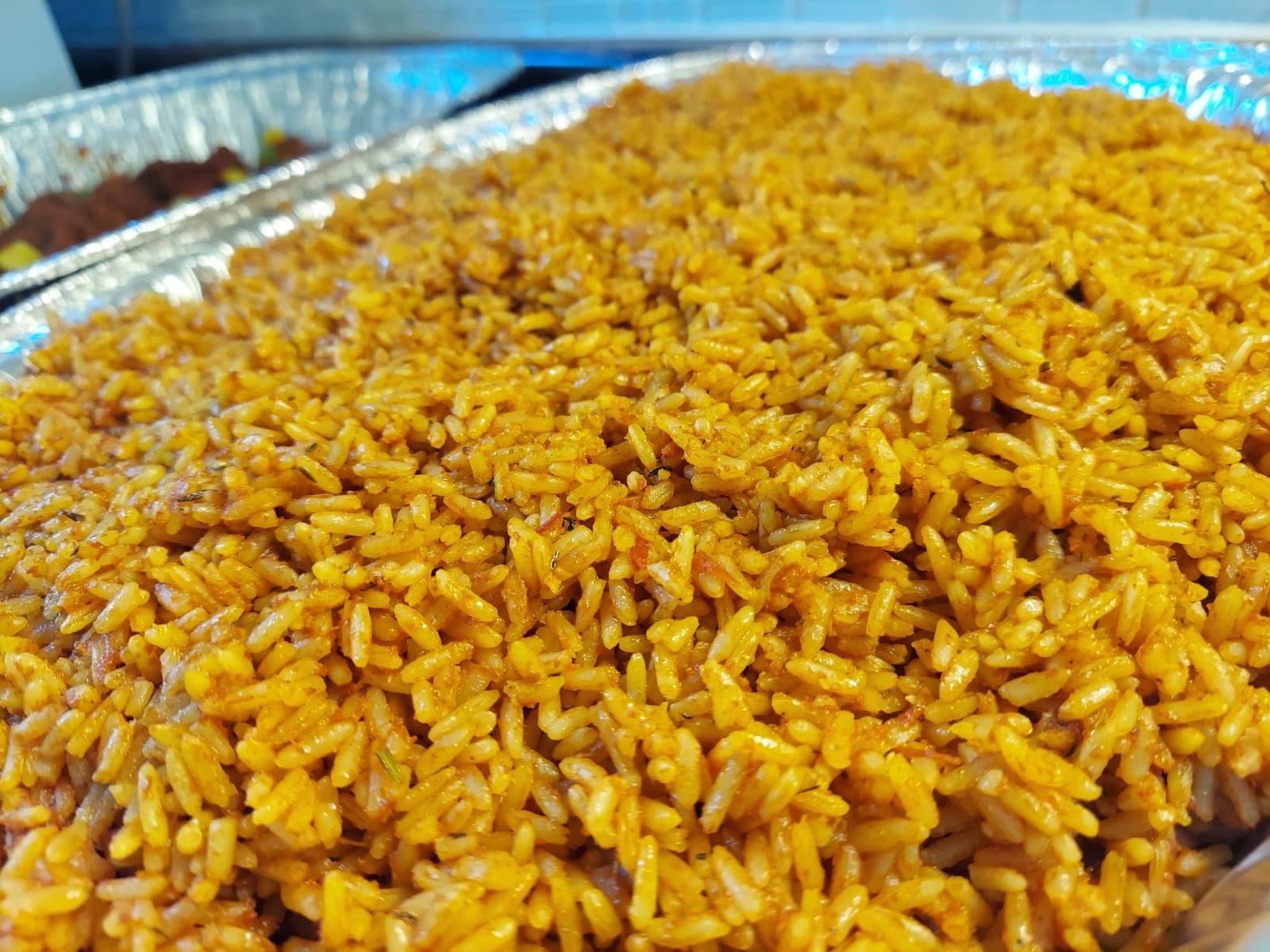 Party jollof rice in a catering tray by Metheq Cuisine