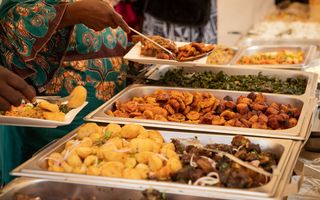 Nigerian buffet catering spread with jollof rice and assorted meats
